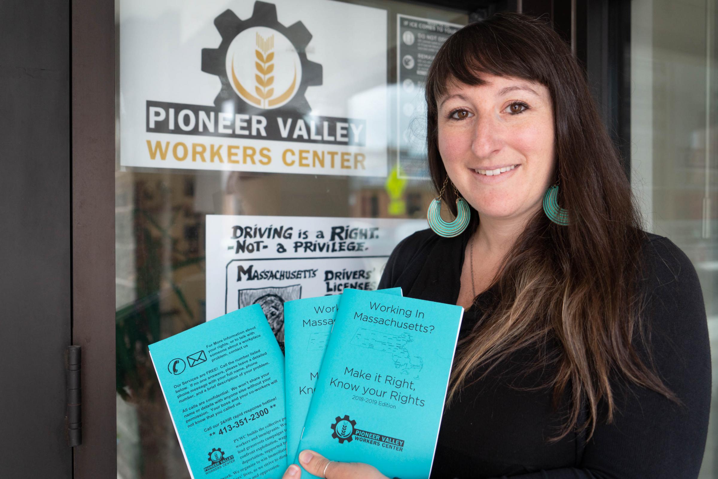 Rose Bookbinder, co-director of the Pioneer Valley Workers Center, holds pamphlets explaining workers rights in Massachusetts. Photo by Ellery Berenger for NEPR