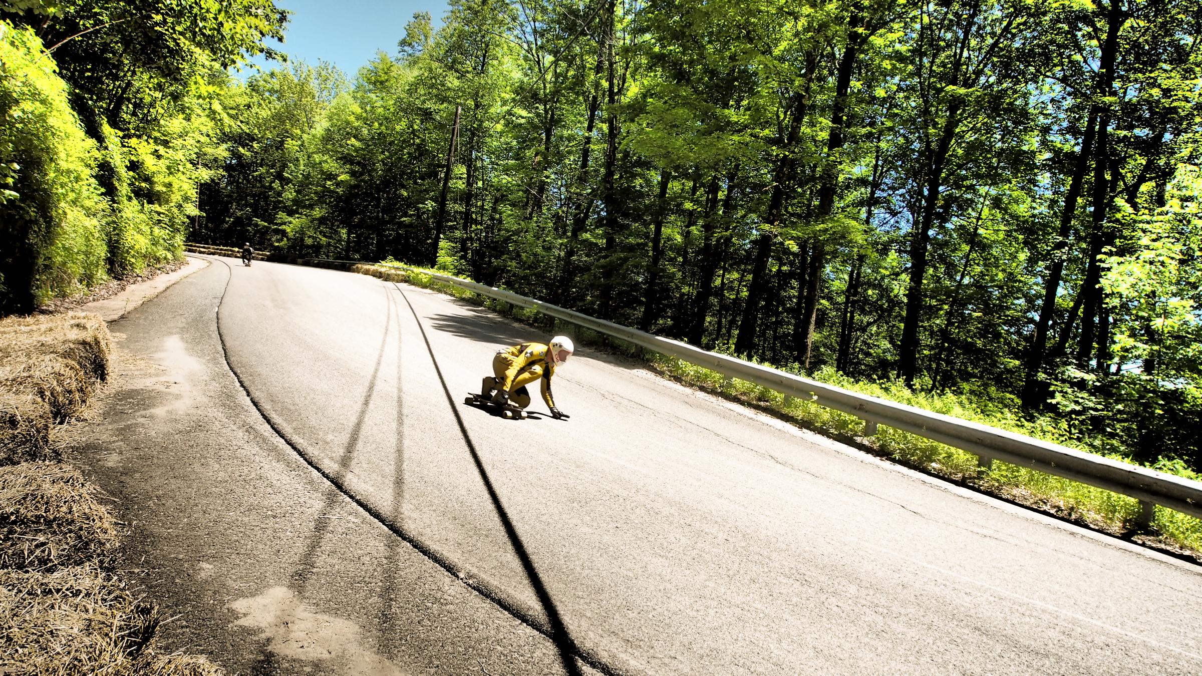 A racer on Whitcomb Hill Road crouches low approaching a part of the racetrack known as "the left slide." Photo by Ben James for NEPR