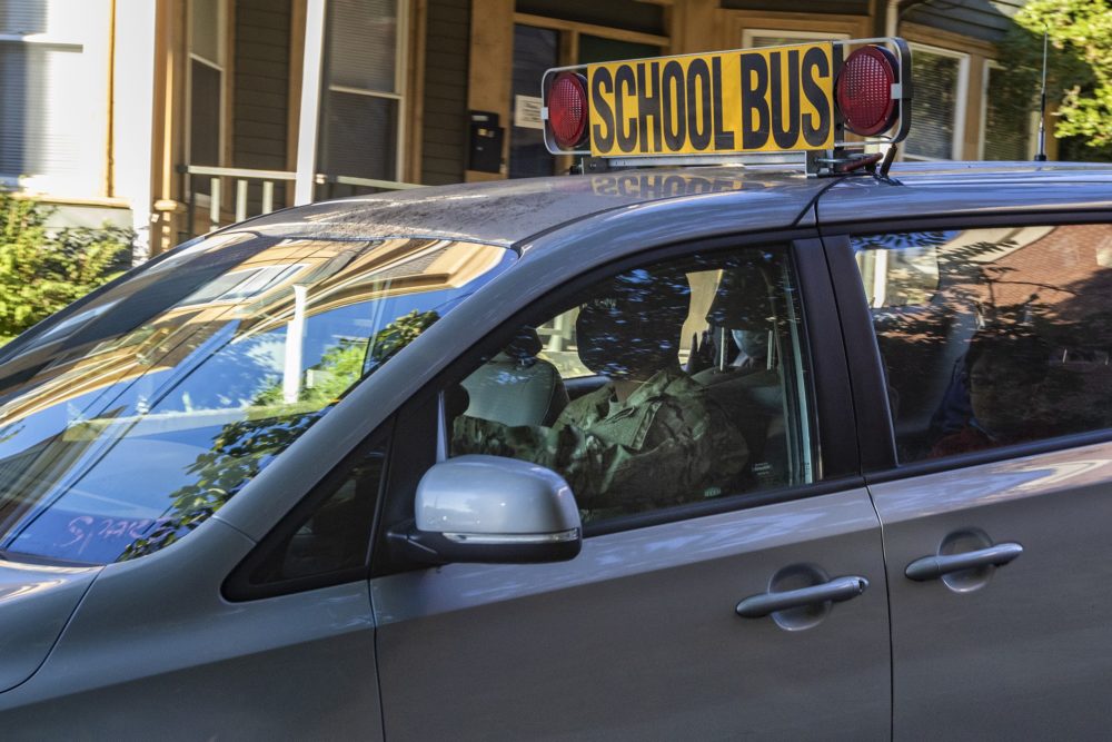 A National Guard member drives a school bus van in Chelsea, Mass.