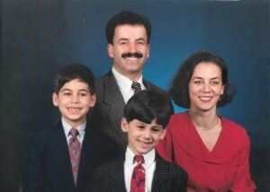 A family portrait of Christopher Helali (left) with his parents and brother in 1996.