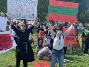 Two protesters hold protest signs