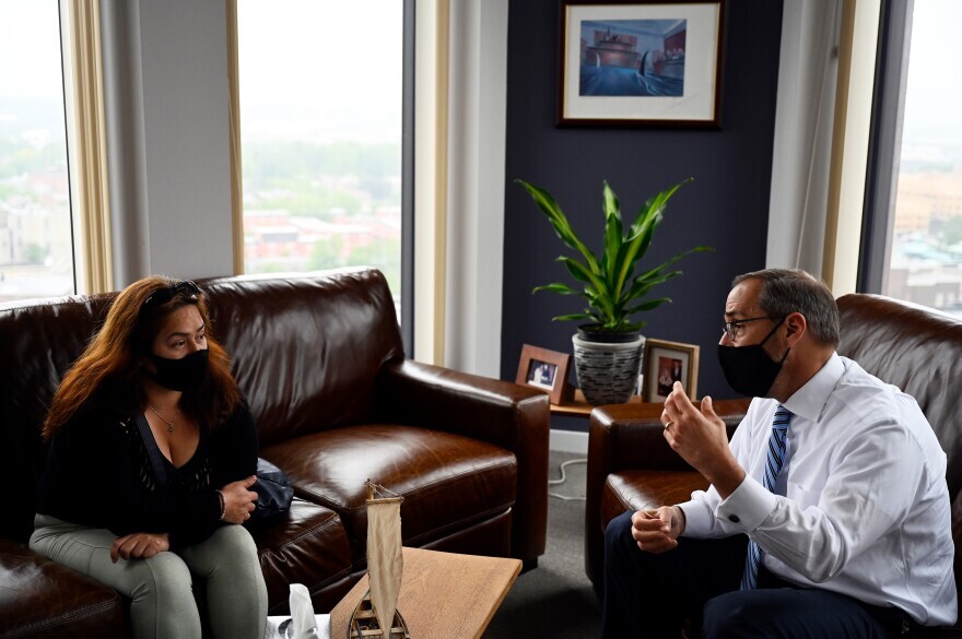 Glenda Cardenas visits with her attorney, Glenn Formica, at his New Haven office.