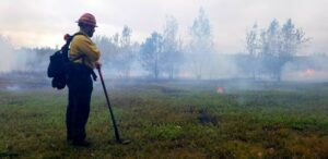 Firefighter is at a controlled burn at the Wells Barren Preserve in Maine.