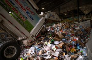 A local trash hauler dumps a load of single-stream recycling into the Materials Innovation and Recycling Authority (MIRA) processing center in Hartford, Connecticut