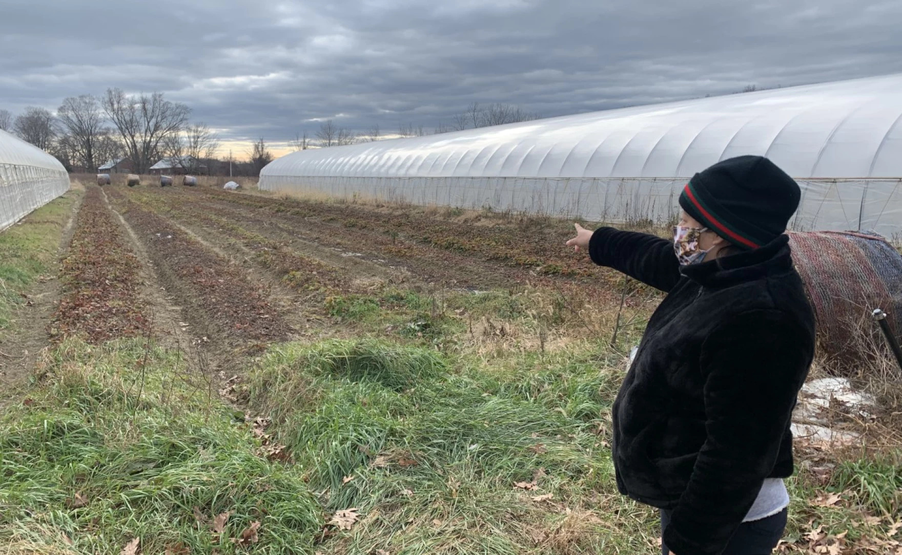 Claudia Rosales pointing to the field in western Massachusetts she worked on as an agricultural farmer.