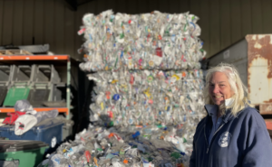 Denise Cumings, crew chief, stands in front of a bale of recycling at the Hooksett Transfer Station in New Hampshire.
