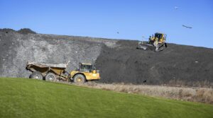 A bulldozer levels ash on a landfill mound beside Covanta's Haverhill waste facility that incinerates trash and generates electricity.