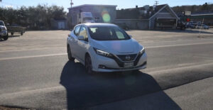 Maine Public has obtained an electric vehicle -- a white Nissan Leaf nicknamed "Pearl," shown here -- that reporters will drive to places across Maine for our Climate Driven series.