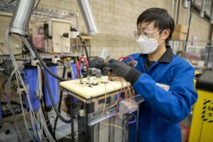 Mechanical engineer Kalina Yang prepares a section of an iron-air battery for testing.