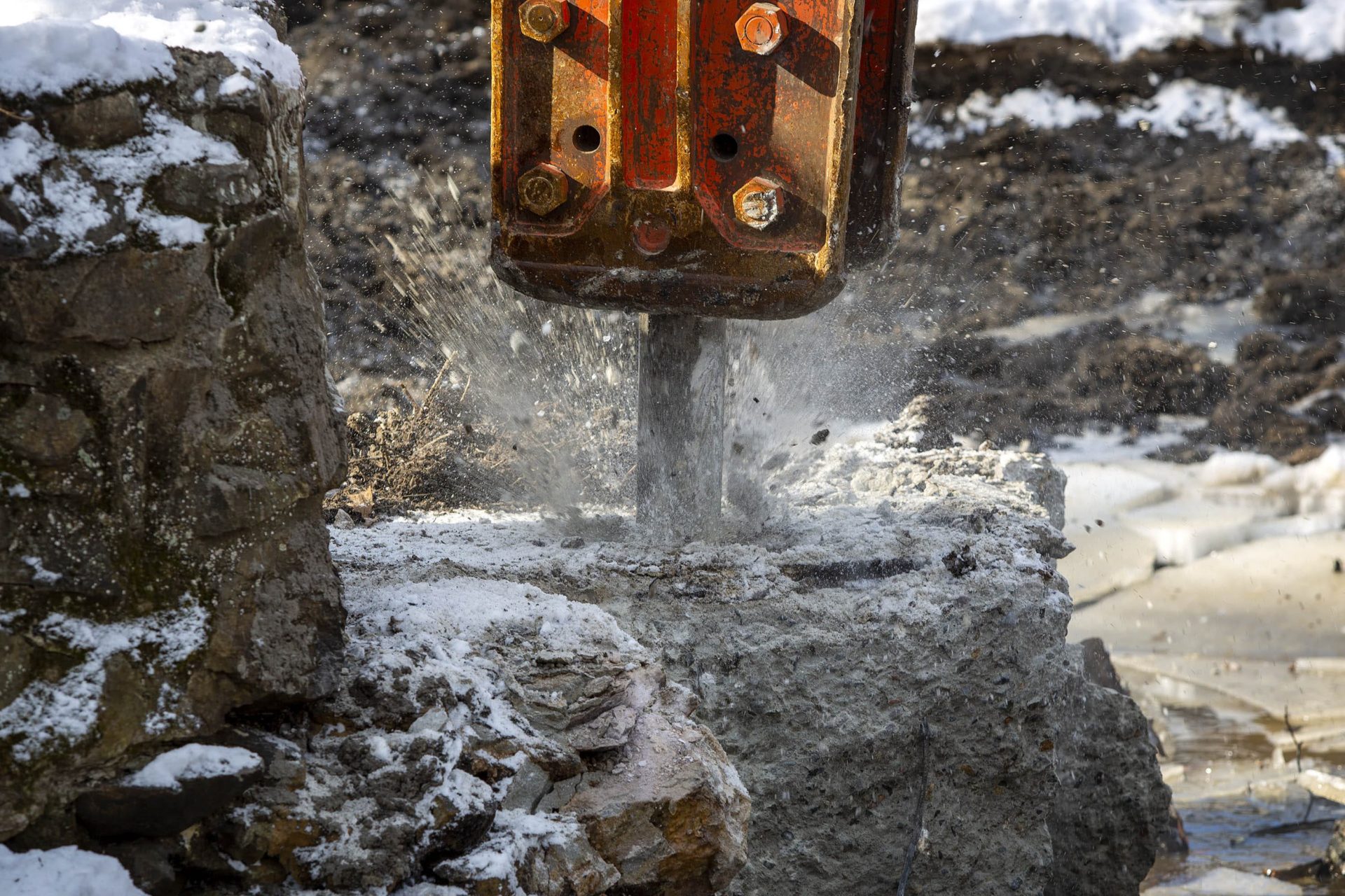 A jackhammer breaks up the spillway of the Mill Pond Dam on Traphole Brook.