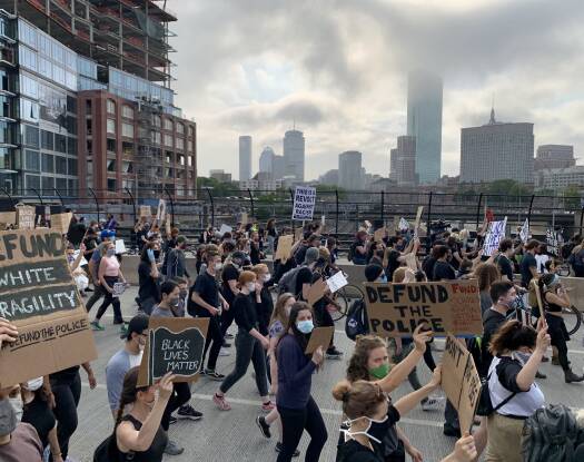 Activists march at a rally to defund the Boston Police Department in 2021.