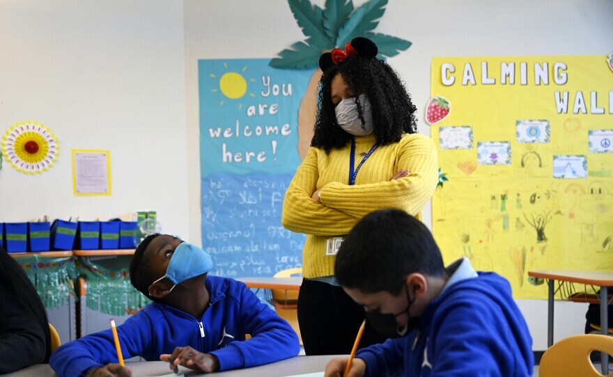 Teacher Adriana Beltran-Rodriguez helps fifth-grader Luwazu Manuel figure out fractions during a math class at Michael D. Fox Elementary School in Hartford, Conn., on March 1, 2022.