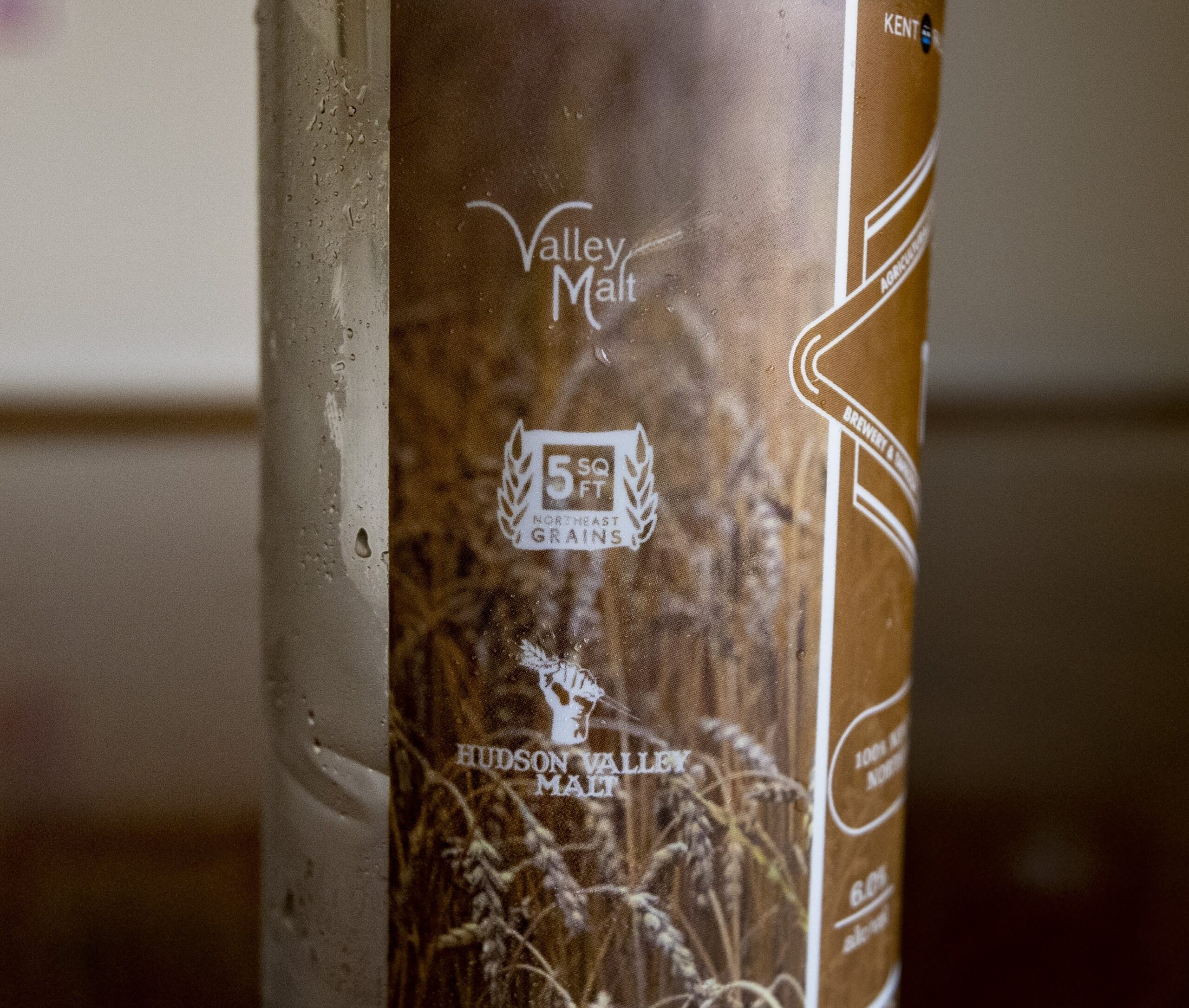 The logo of the Northeast Grainshed Alliance SQFT Project on the can indicates that each 16oz Exhibit ‘A’ Raising the Grain can of beer uses 5 square feet of local farmland. The project’s mission is to bridge the gap in consumer awareness of Northeast grain farmland. 