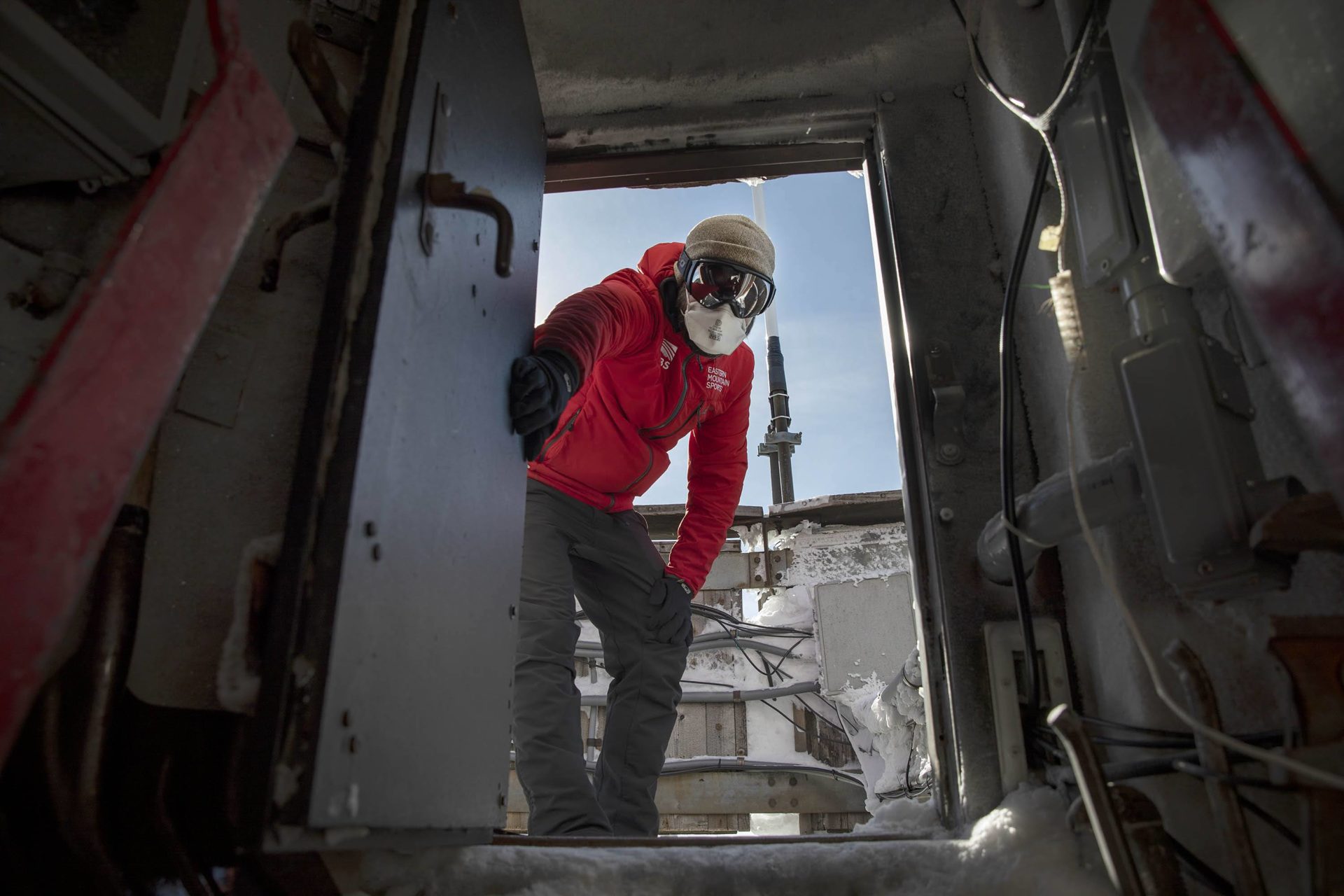 Science and education director Brian Fitzgerald holds open the door at the top of the weather tower at the Mount Washington Observatory. 