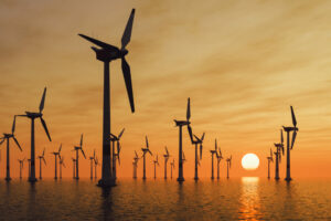 Offshore wind turbines at sunset.