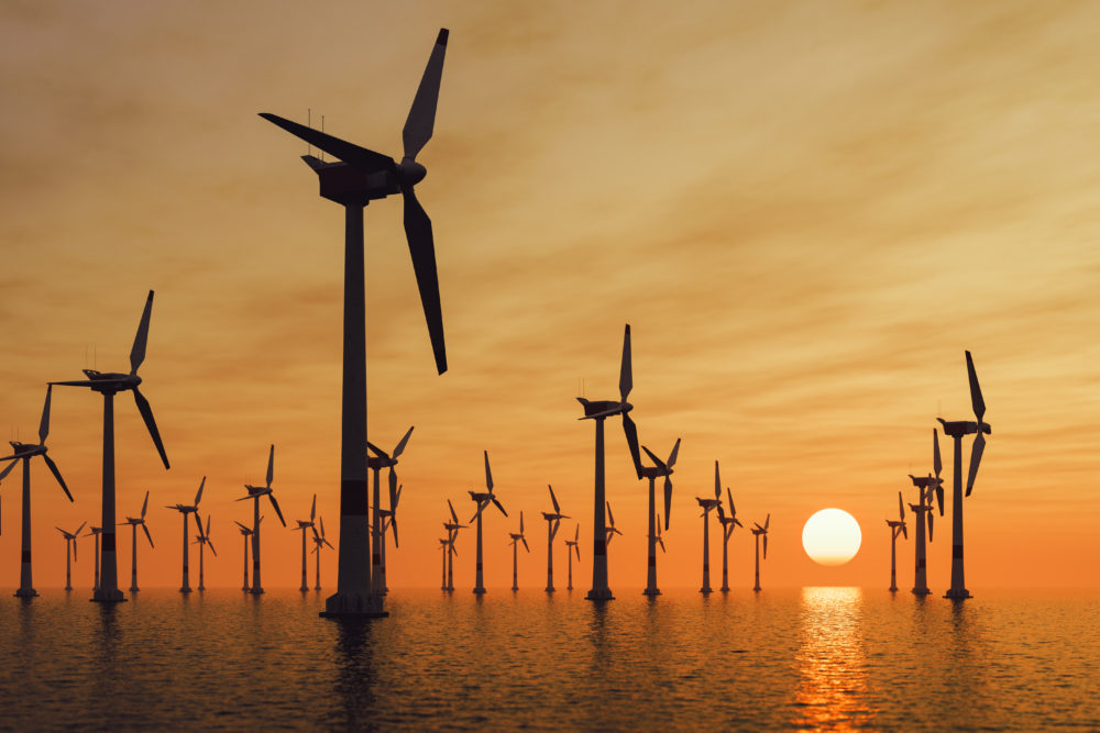 Offshore wind turbines at sunset. 