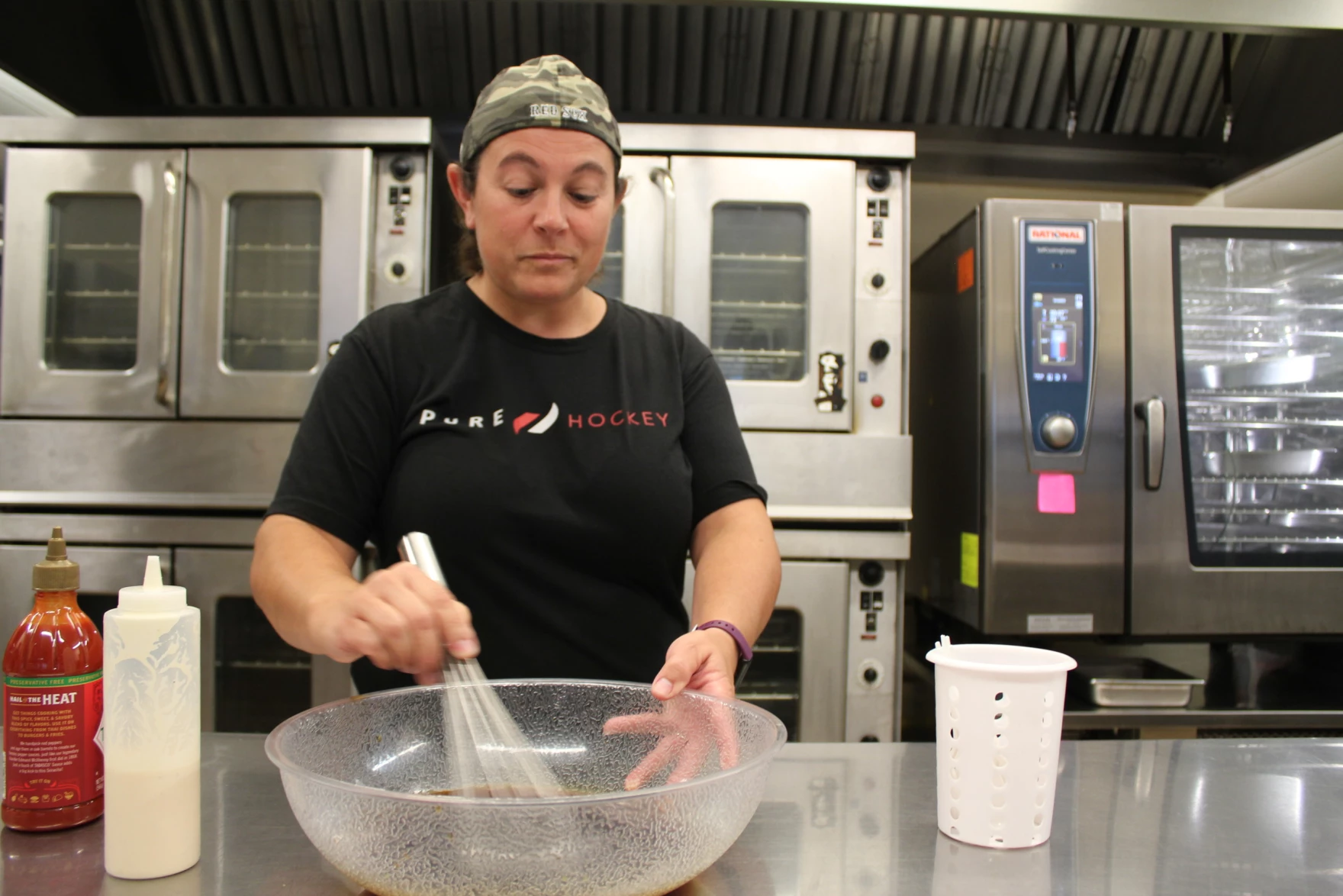 Workers prepare meals as part of a training at Windham High School in Maine.