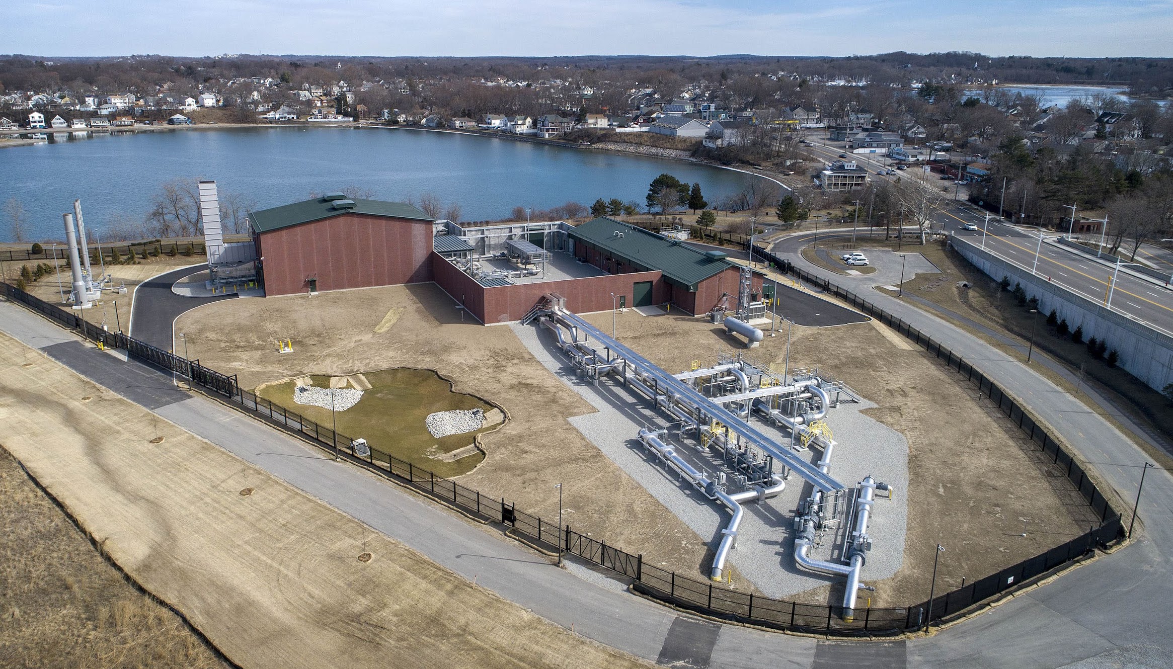 An aerial photo of Weymouth gas compressor station, which is located next to a body of water.