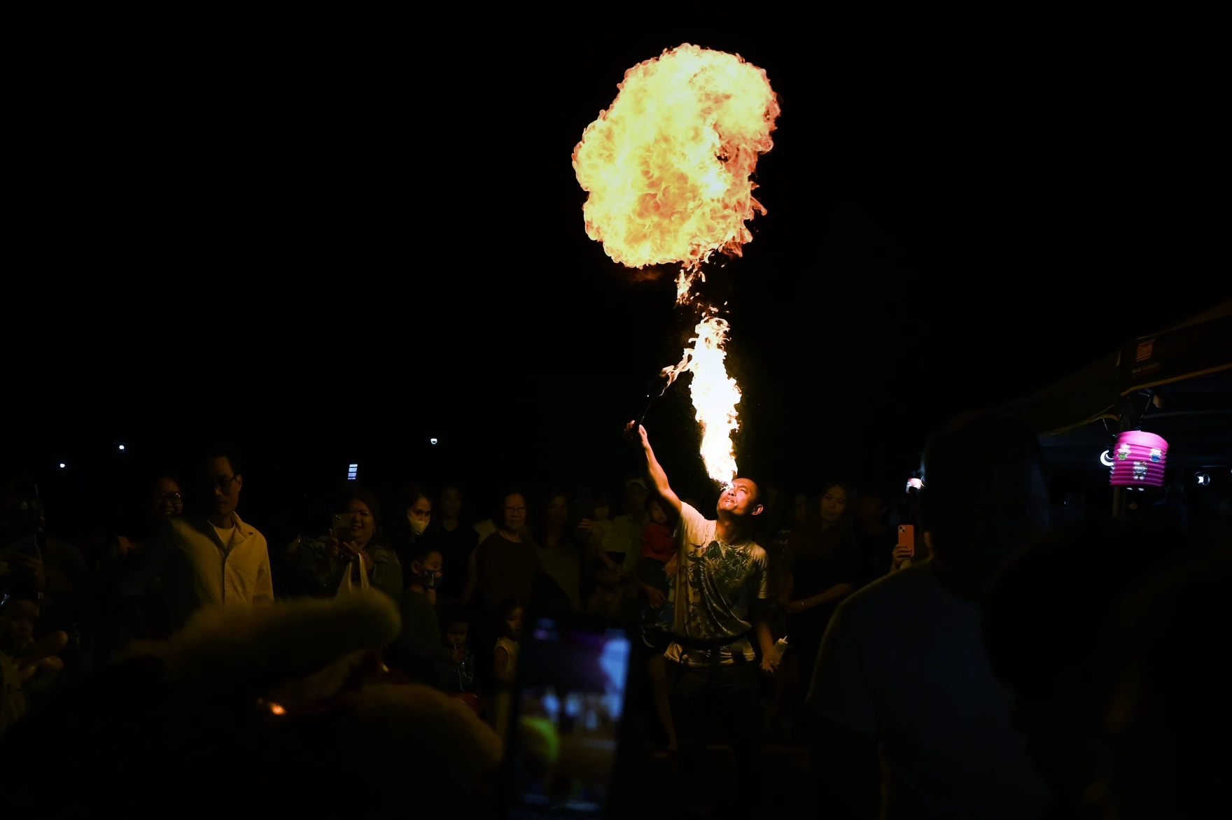 At night, a man breathes fire to lead the Lion Dance for luck that represents prosperity and goodness in every home. The dance took place during the Mid-Autumn Festival celebrated by St. Andrew Dung-Lac Parish in West Hartford, Connecticut, Sept. 3, 2022.