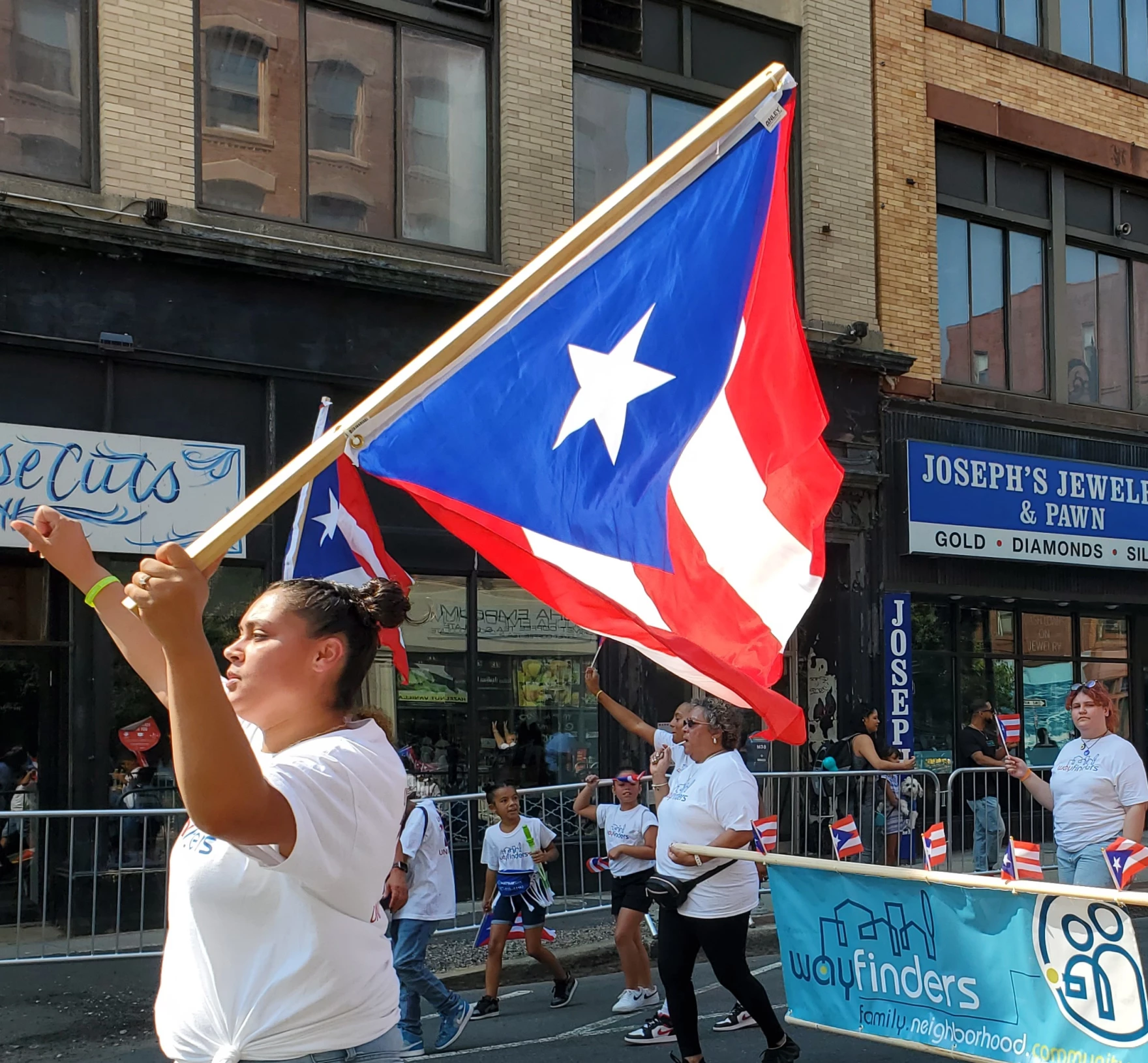 A woman holds a Puerto Rican flag during the Springfield Puerto Rican Parade on Sept. 18, 2022.