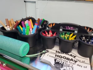 Organized school supplies such as markers, different crayons like red, green and black, in a preschool classroom in Springfield, Massachusetts.