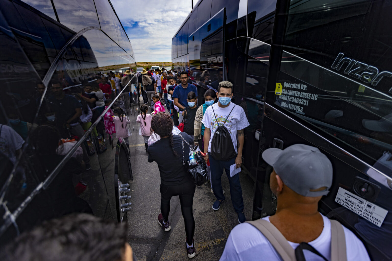 Immigrants prepare to board a charter bus bound for Chicago at the Immigration Welcome Center in El Paso. 