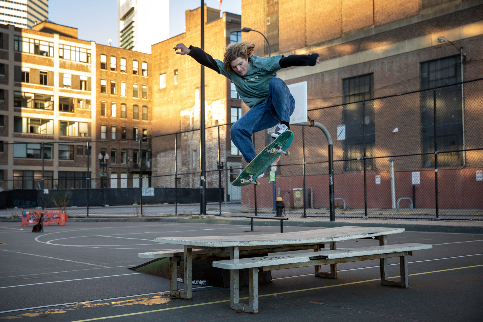 Skateboarder Larkin Tanner, a BU student from Hull, flies over a table at Reggie Wong Park. 
