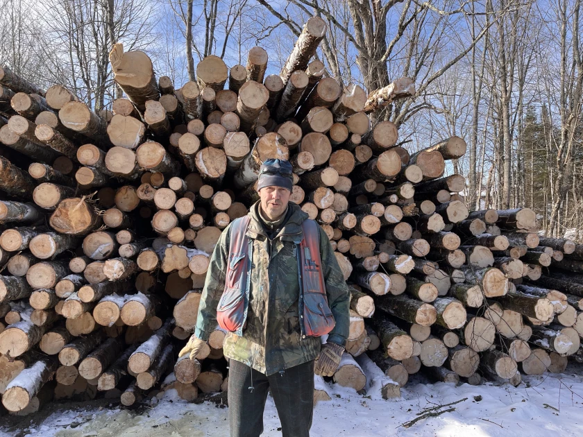 Forester David Senio, standing in front of a pile of balsam fir logs, said responsibly managing forests can make them healthier in the long run.