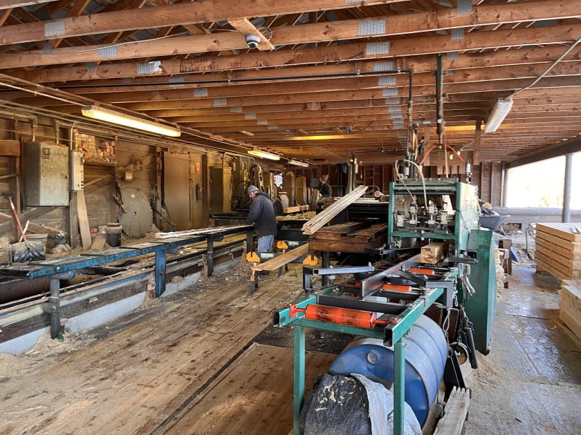 Workers at Goodridge Lumber in Albany, Vermont operate the company's sawmill. Goodridge's store of logs is running low, due to warm temperatures that have limited the timber harvest.