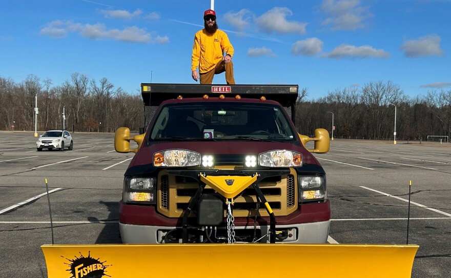 Harold Davis stands on his snow plow truck, which he bought this fall.