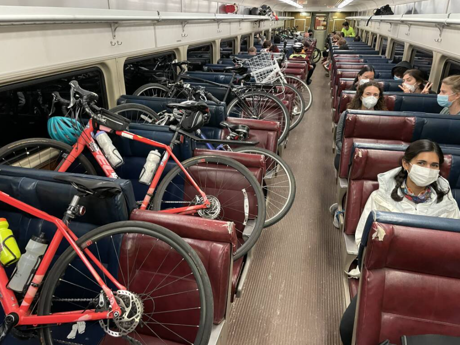 Bikers take a late night commuter rail train to get near the marathon starting line in 2022.