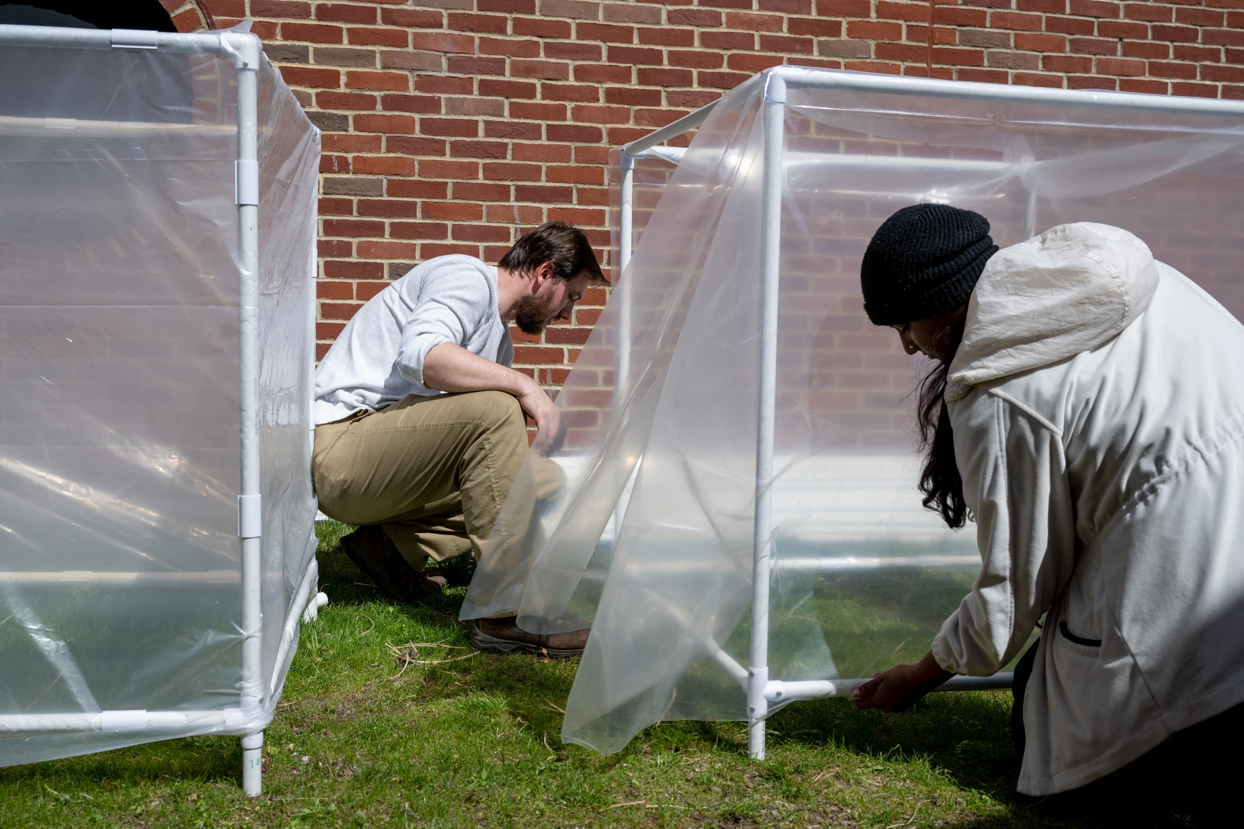 Maritime Aquarium Conservation Project Manager Justin Susarchick, left, and Conservation Research Assistant Rebha Raviraj are with a team of researchers building greenhouses to find out which strains of Spartina Alterniflora, or cordgrass, can survive the region's warming climate. 