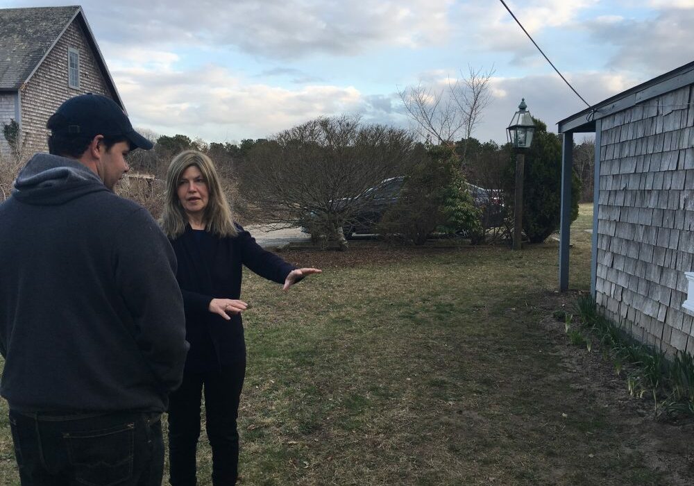 Wescley Pereira and Gail Meister chat about a yard project. The two have been neighbors on Martha’s Vineyard for more than a decade. Photo by Shannon Dooling for WBUR.