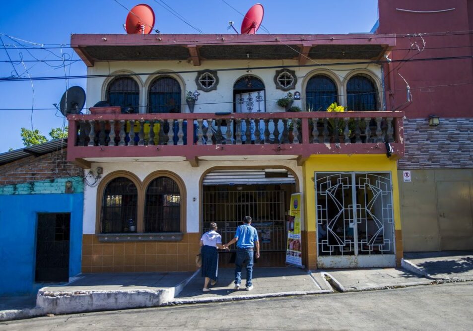 A couple walk hand-in-hand into Panaderia Pacita Quintanilla in San Vicente, El Salvador. Photo by Jesse Costa for WBUR