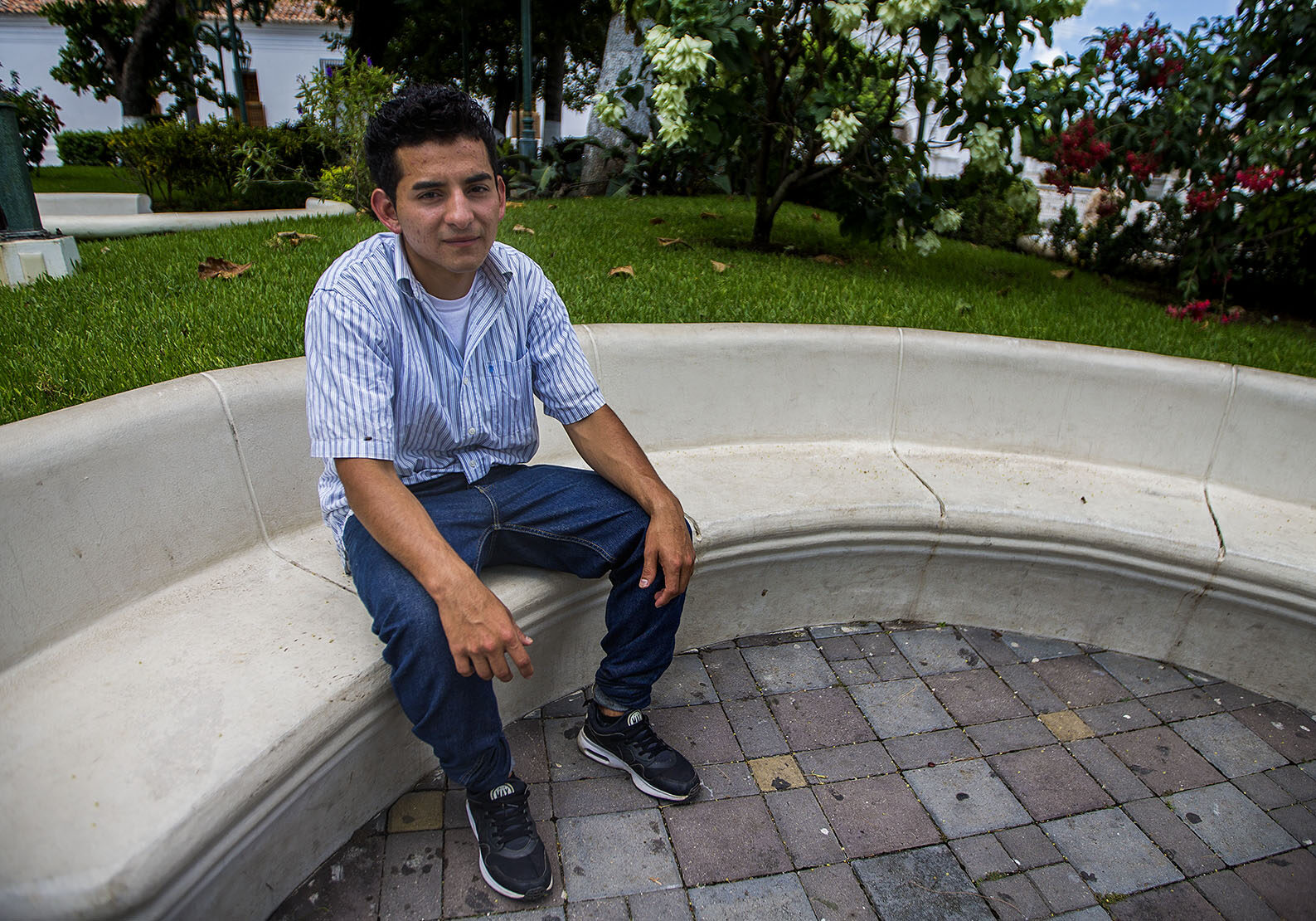 Orlando sits in a plaza in Metapán, El Salvador. Photo by Jesse Costa for WBUR