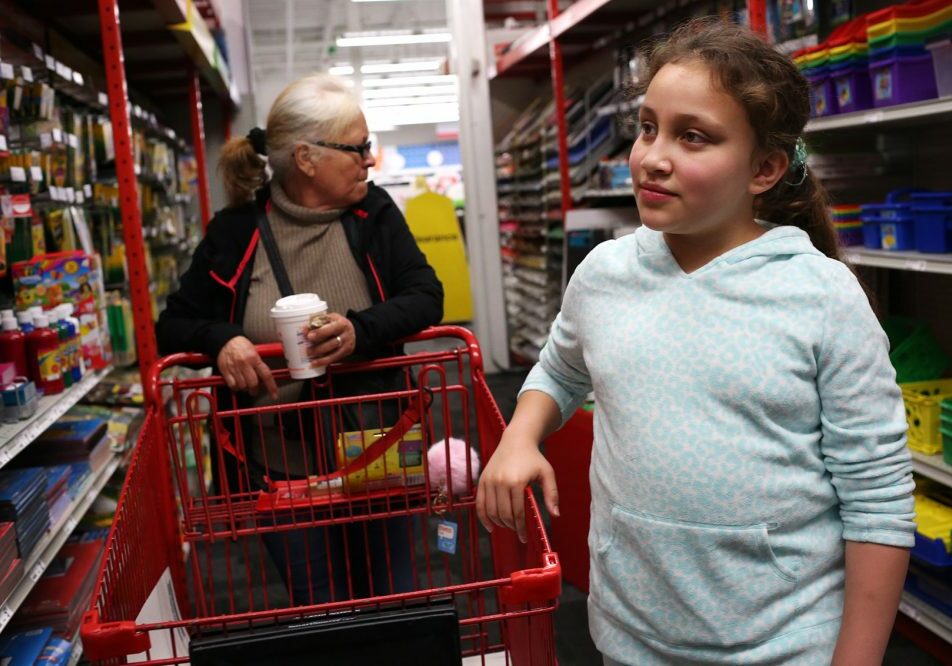 Mellanie Rodriguez, Francisco Rodriguez's 10-year-old daughter, goes shopping for school supplies with her grandmother, Jesus Rodriguez, on Saturday. Photo by Hadley Green for WBUR
