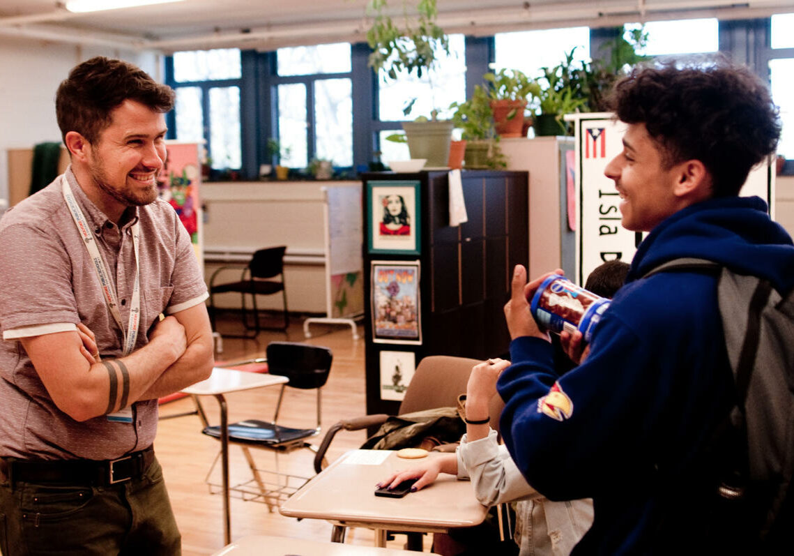 Pa'lante director Luke Woodward speaks with peer leader David Serrano, a sophomore, in the student support room. Photo by Ben James for NEPR