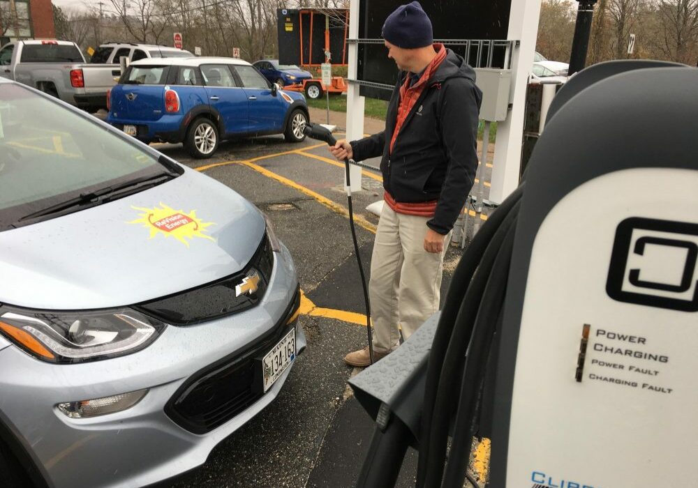ReVision Energy's Barry Woods charges up his company car in Brunswick, Maine. Photo by Fred Bever for Maine Public