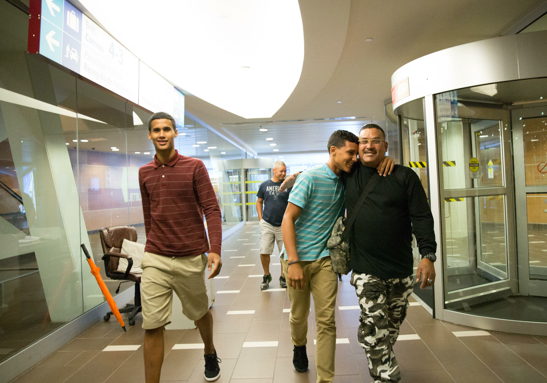 Guillermo Class reunites with his two sons in the San Juan Airport. He sold his car to fly them back to Hartford.
Photo by Ryan Caron King for WNPR