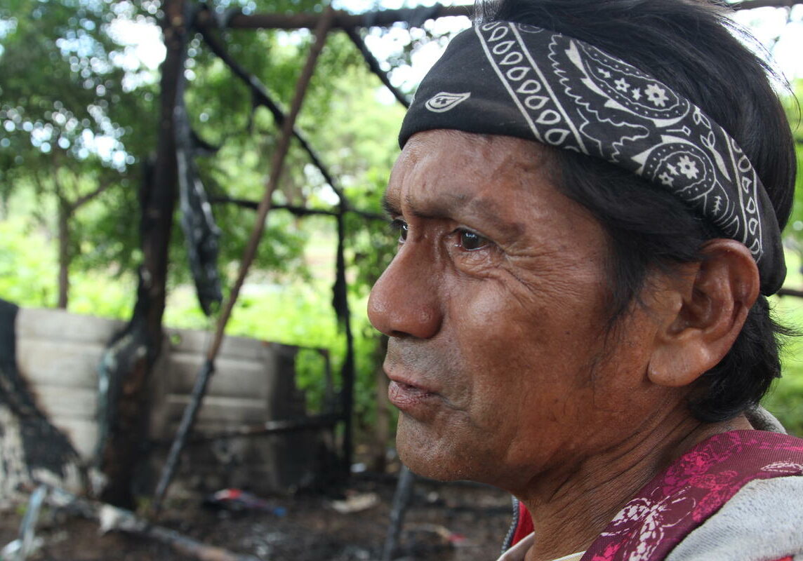 Rafael Morales stands in front of his home hours after he and neighbors allege Nicaraguan police burned it down. The motive for the attack is unclear as Morales said he is a Sandinista government supporter. Photo by Lorne Matalon for VPR