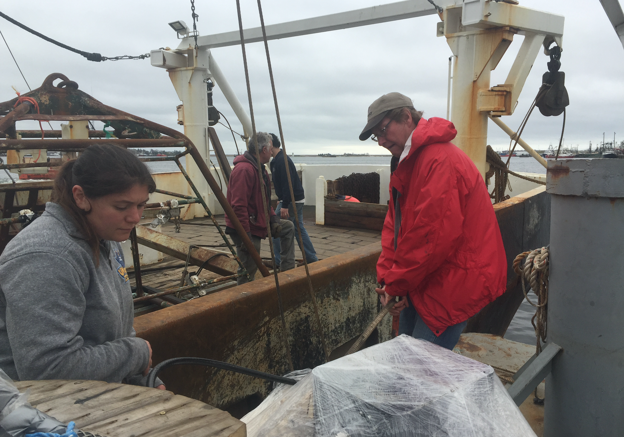 Dr. Kevin Stokebury, right, and his team on boat Liberty preparing for the last sea scallop survey before Vineyard Wind begins construction. Photo by Nadine Sebai for The Public's Radio