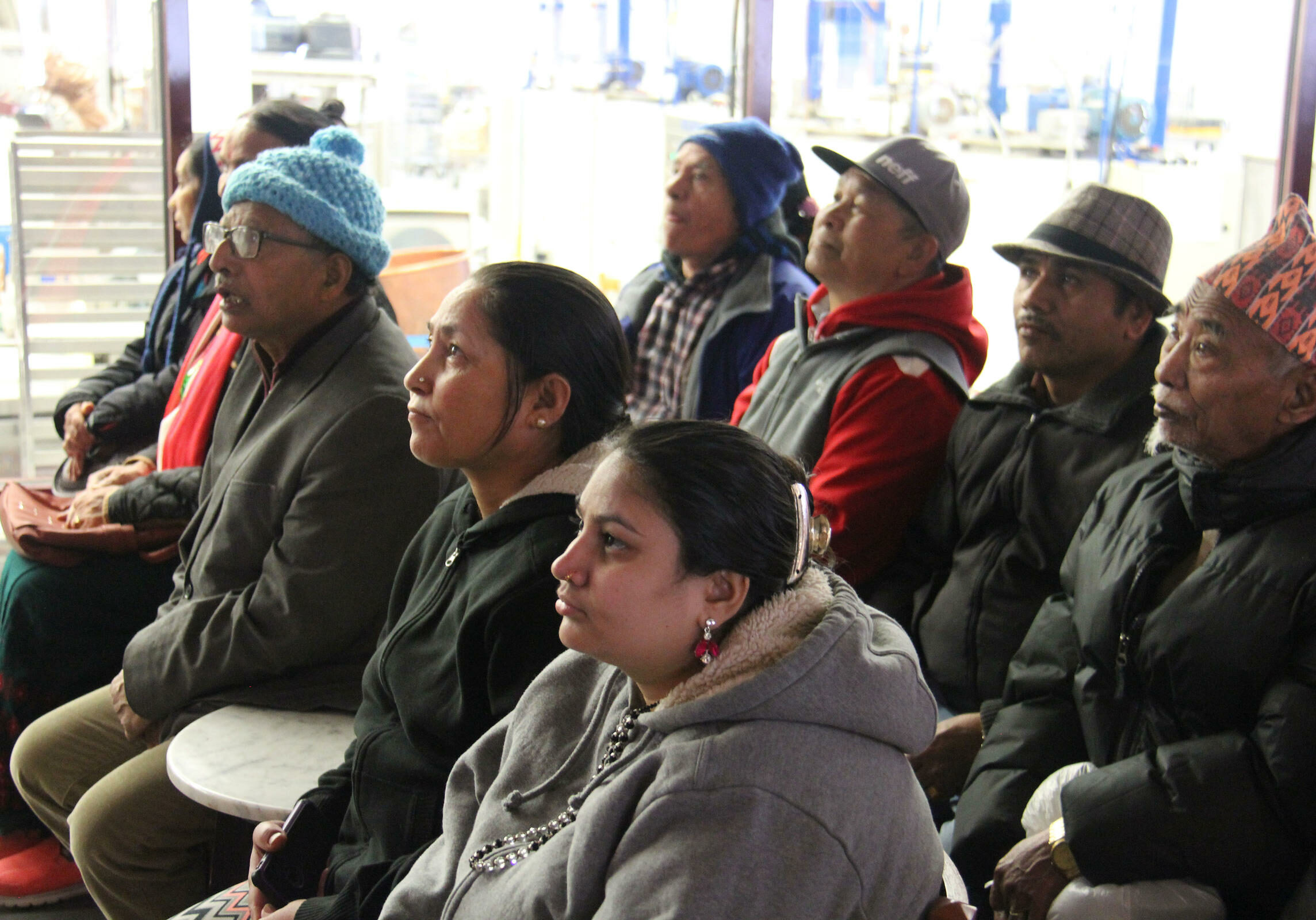 Ajuda Thapa, center in black, learns about Lake Champlain Chocolates on an outing with other Bhutanese refugees who have sought mental health treatment at UVM's Connecting Cultures clinic. Photo by Kathleen Masterson for VPR