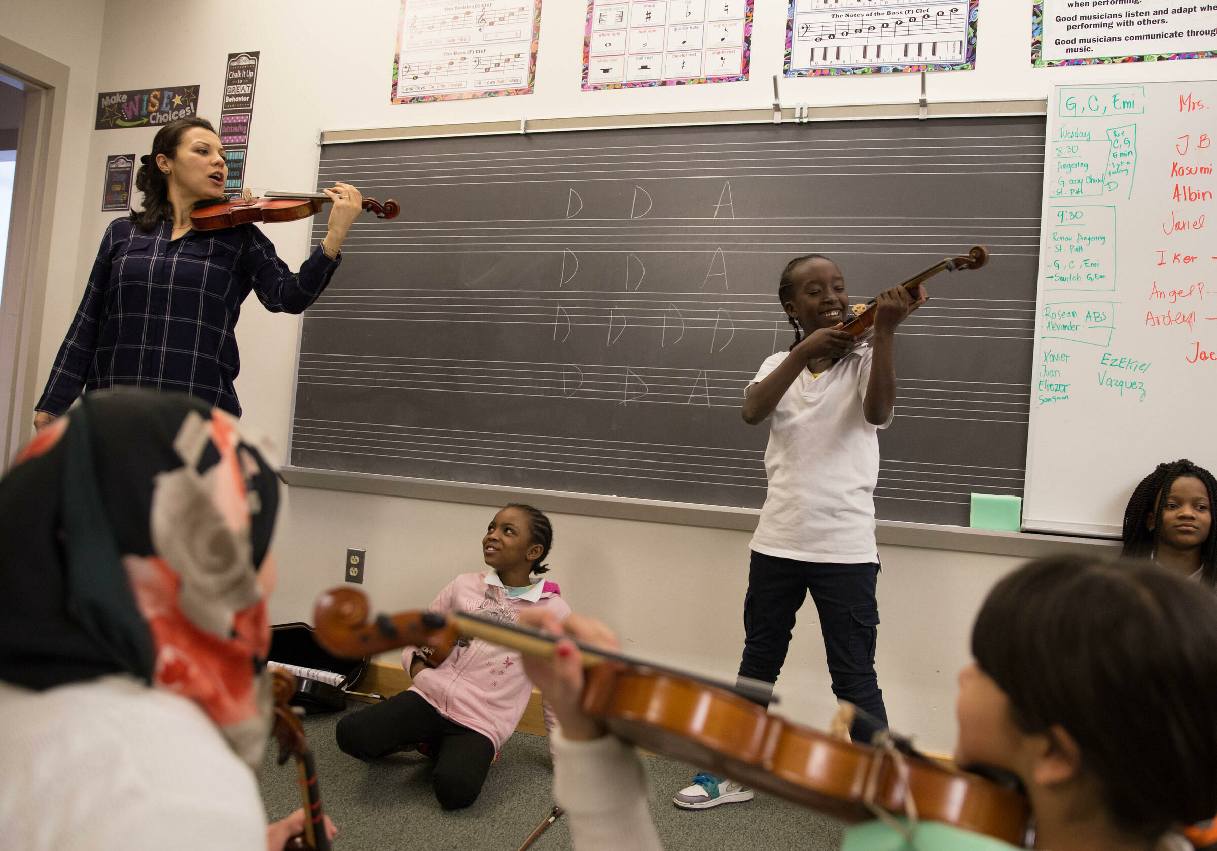 Yaira Matyakubova leads the violin class for young refugees. Photo by Ryan Caron King for WNPR